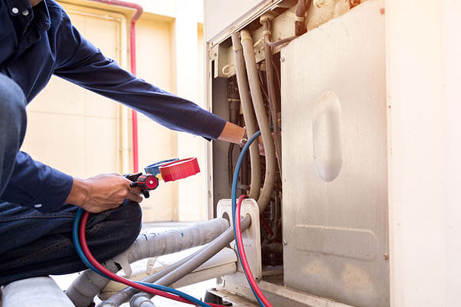 Experienced AC technician servicing an air conditioner